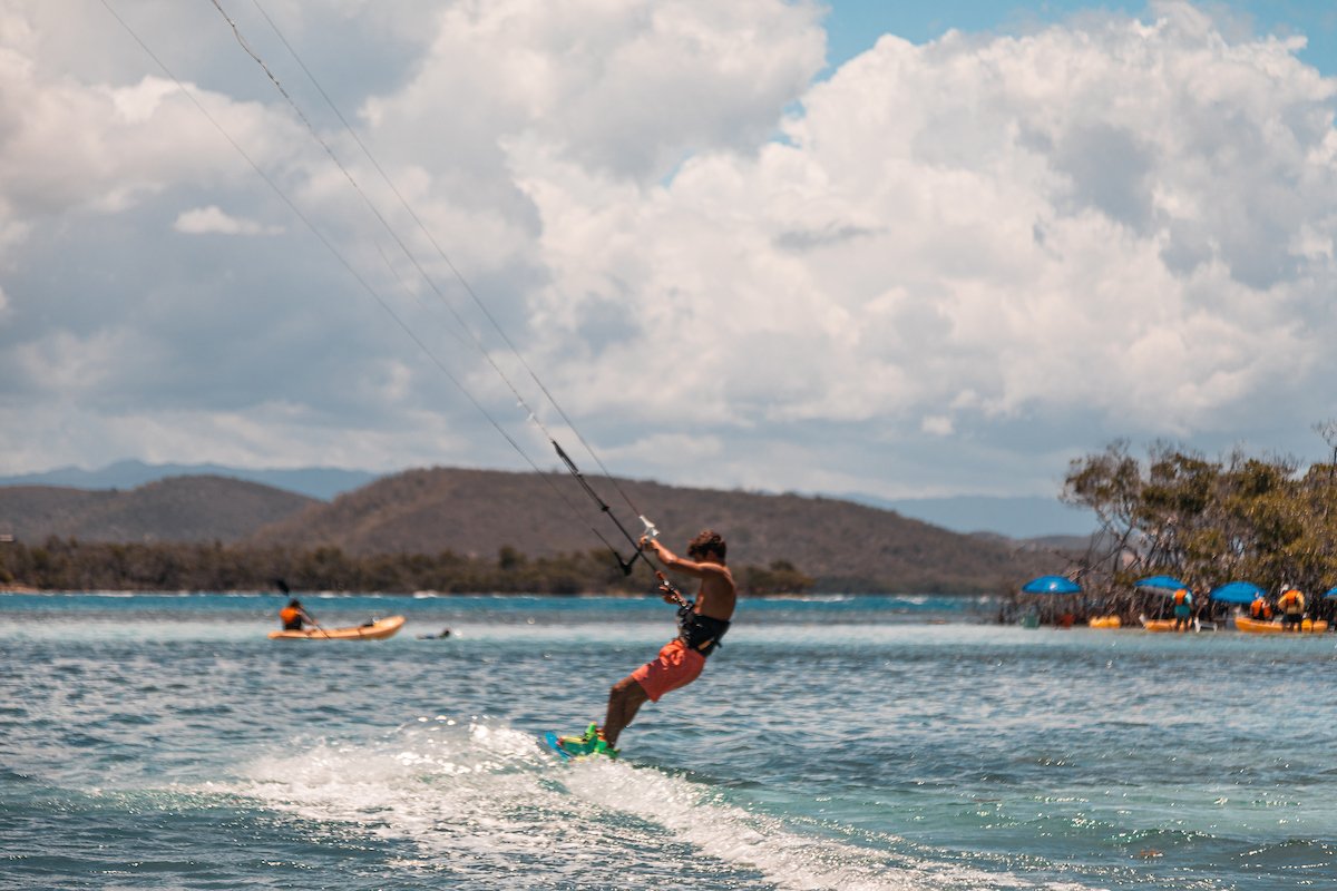A man windsurfs across La Parguera in Lajas