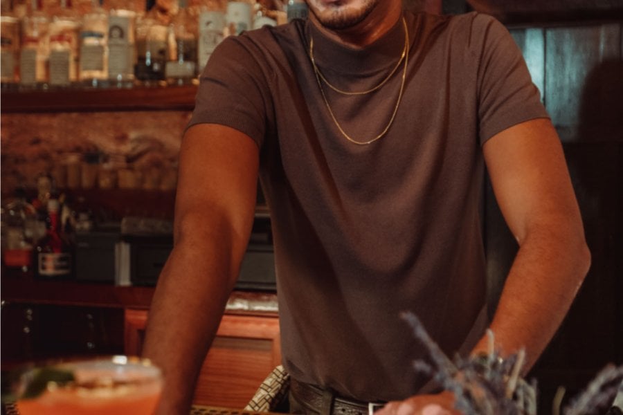 A bartender serves a drink at a bar in Puerto Rico