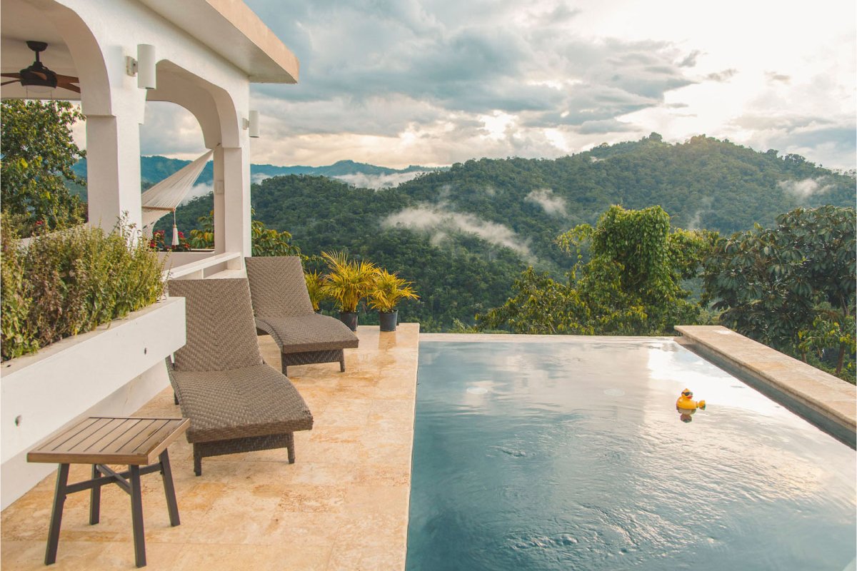 An infinity pool overlooks the rainforest at Villa Serena, a vacation rental in Puerto Rico.