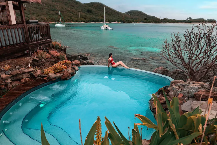 Woman enjoying ocean view from private pool at Puerto Rico rental home