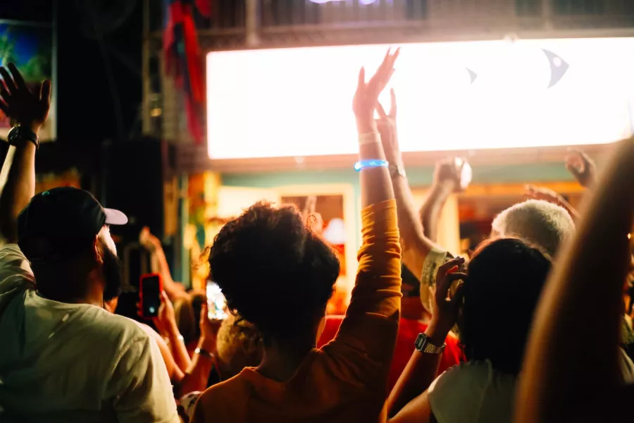 Crowd with raised hands enjoying music at a live show in Puerto Rico.