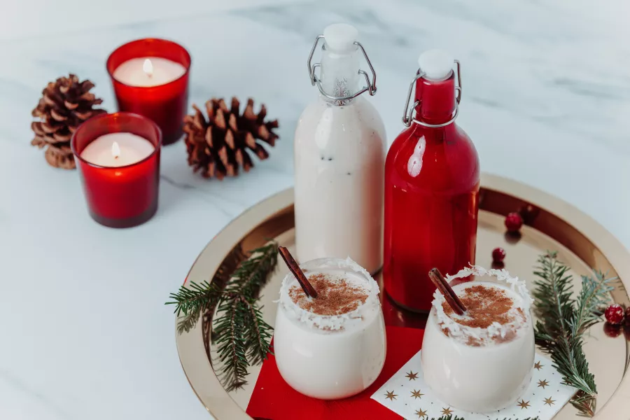 Coquito, a traditional Puerto Rican Christmas drink, served in bottles and glasses during the holiday season.