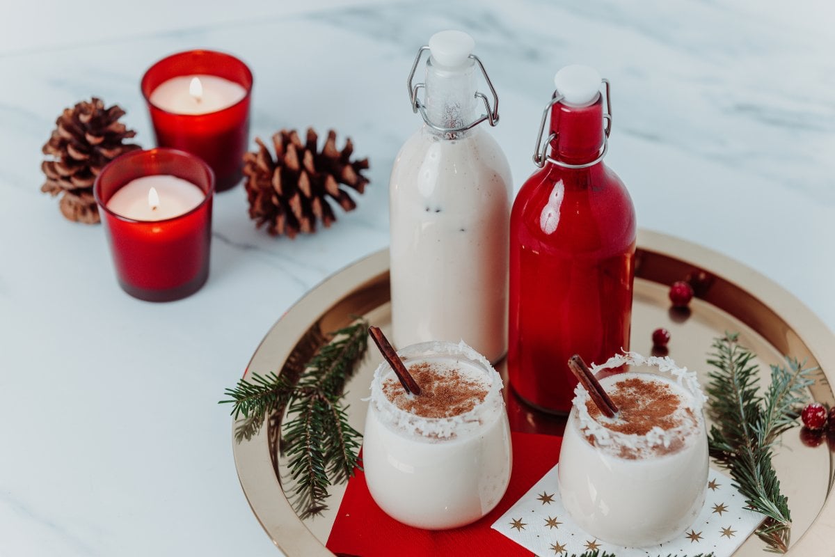 Coquito, a traditional Puerto Rican Christmas drink, served in bottles and glasses during the holiday season.