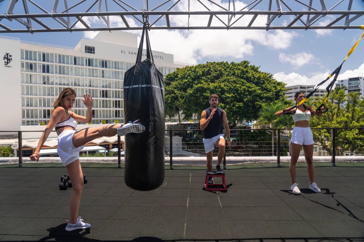 Group of people working out at rooftop gym.