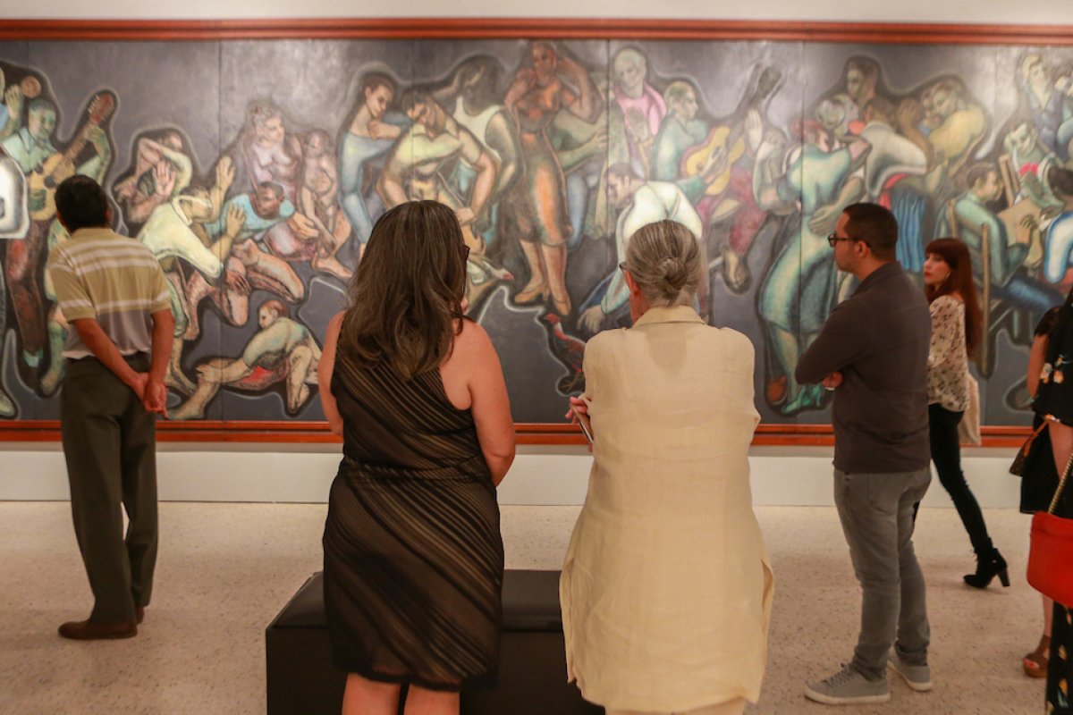 People admire a great painting in a museum