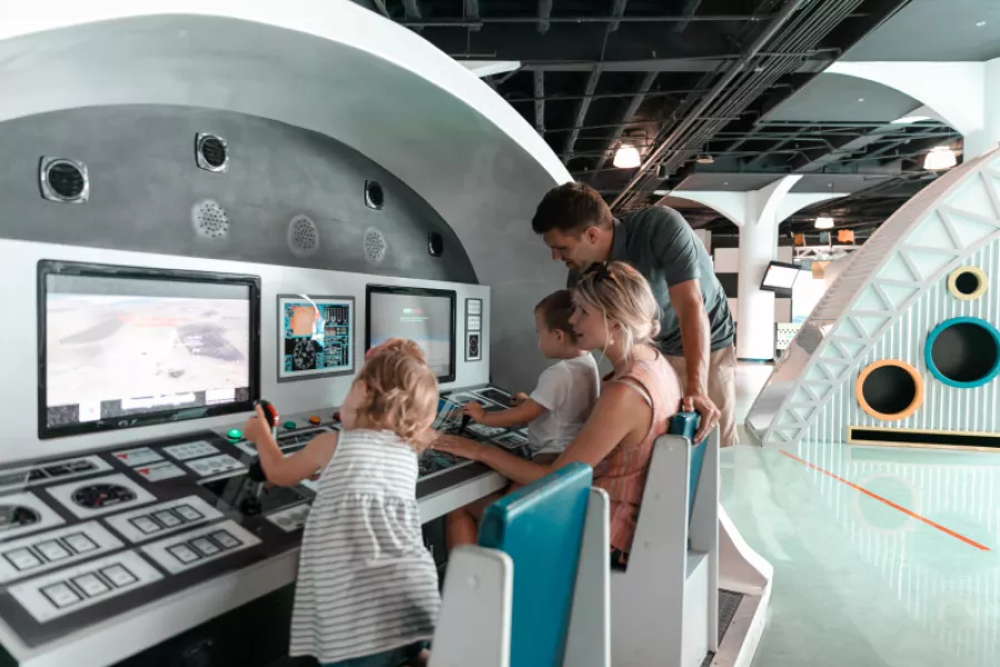 A family interacts with an exhibit at Museo Del Nino Carolina.