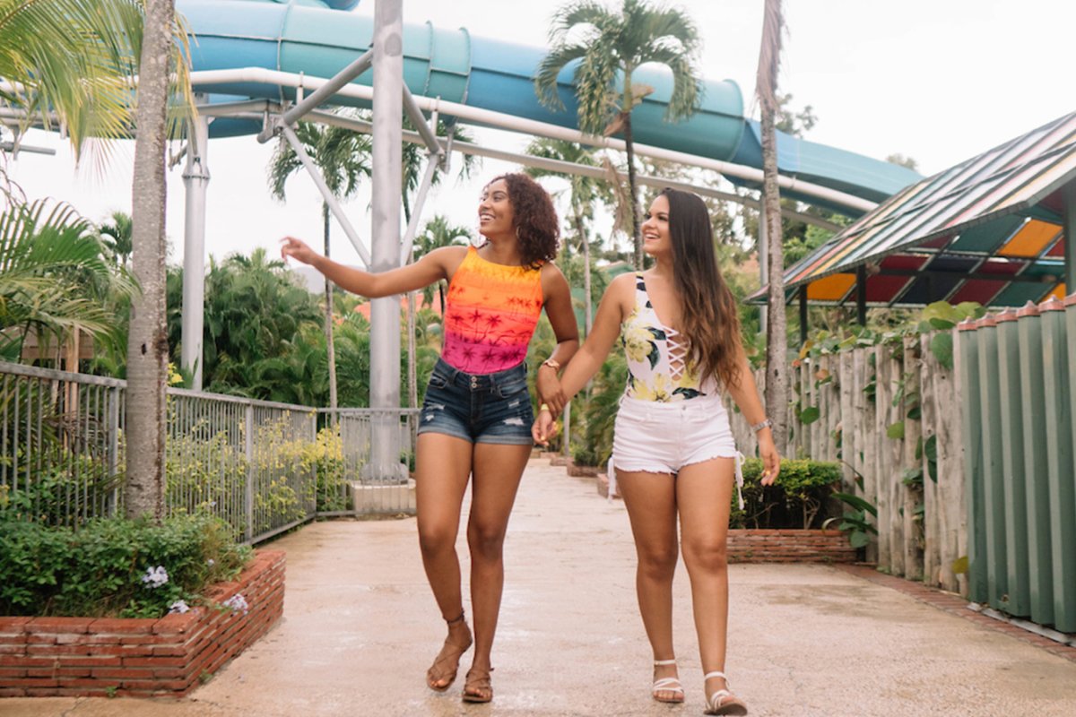 Two teen girls walking around the Olimpia Water Park during the summer in Salinas, Puerto Rico.