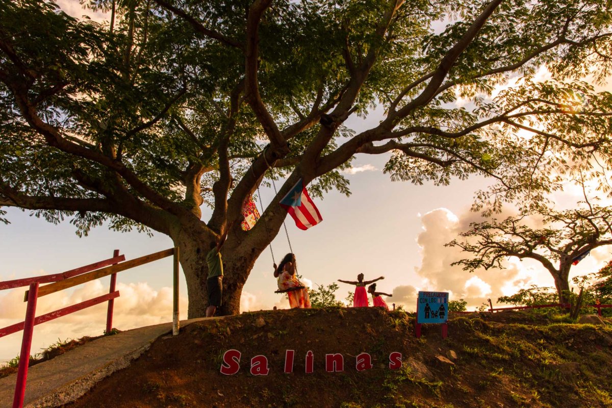 A family plays on a swing on a mountainside in Salinas, Puerto Rico.