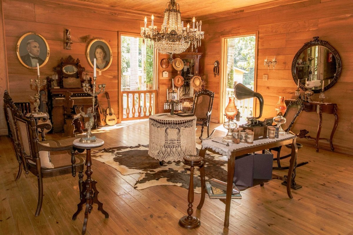 An opulent chandelier and Victorian-era furnishings fill a wood-paneled room at Hacienda Lealtad, a 19th-century coffee plantation in Lares, Puerto Rico.