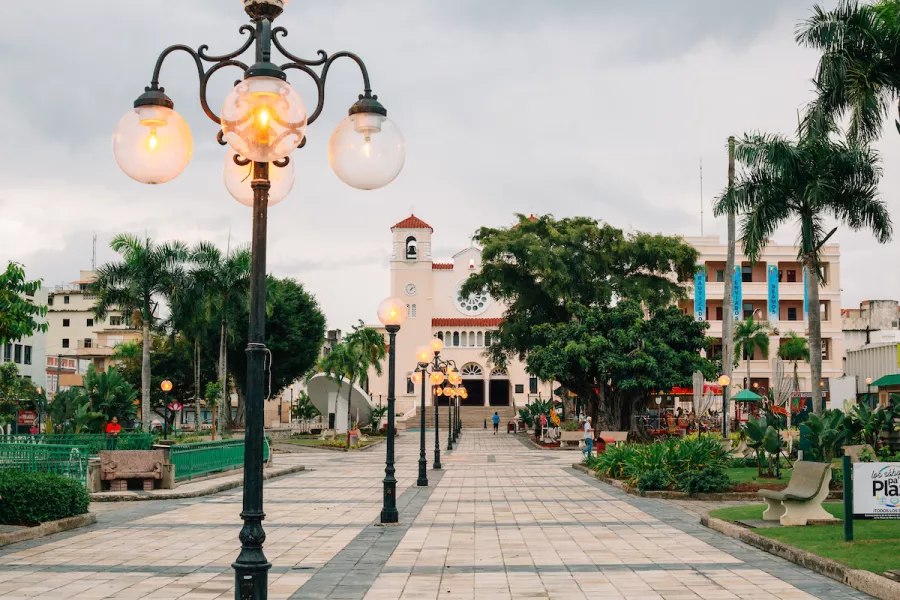 A historic plaza is lined with vintage-style lamp posts in Caguas, Puerto Rico.