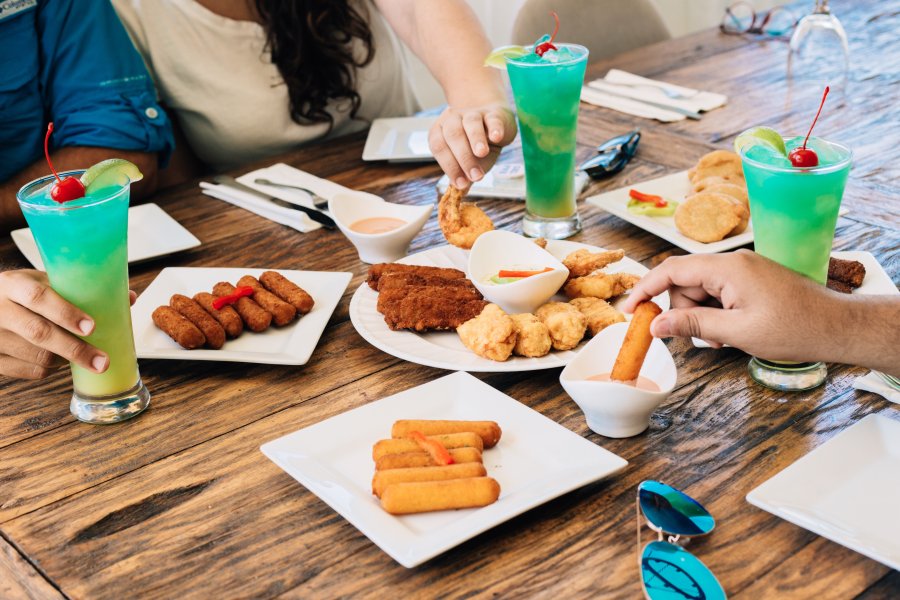 Dinner table filled with appetizers and drinks.