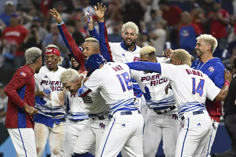 Puerto Rican baseball players with blonde hair celebrating victory
