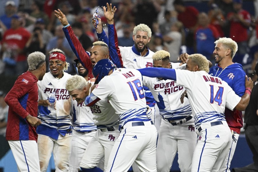Group of baseball players with dyed blonde hair celebrating.