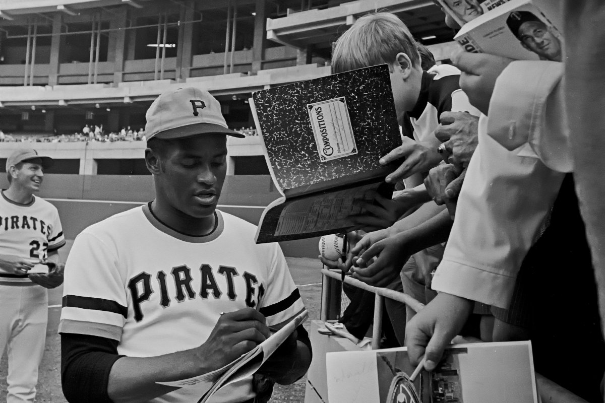Roberto Clemente signing autographs.