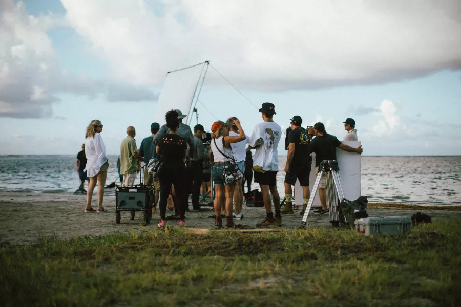 Group filming at the beach.