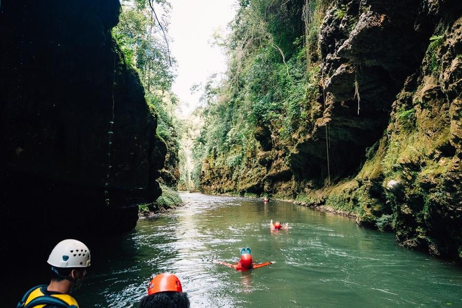 Group of people floating down a river.