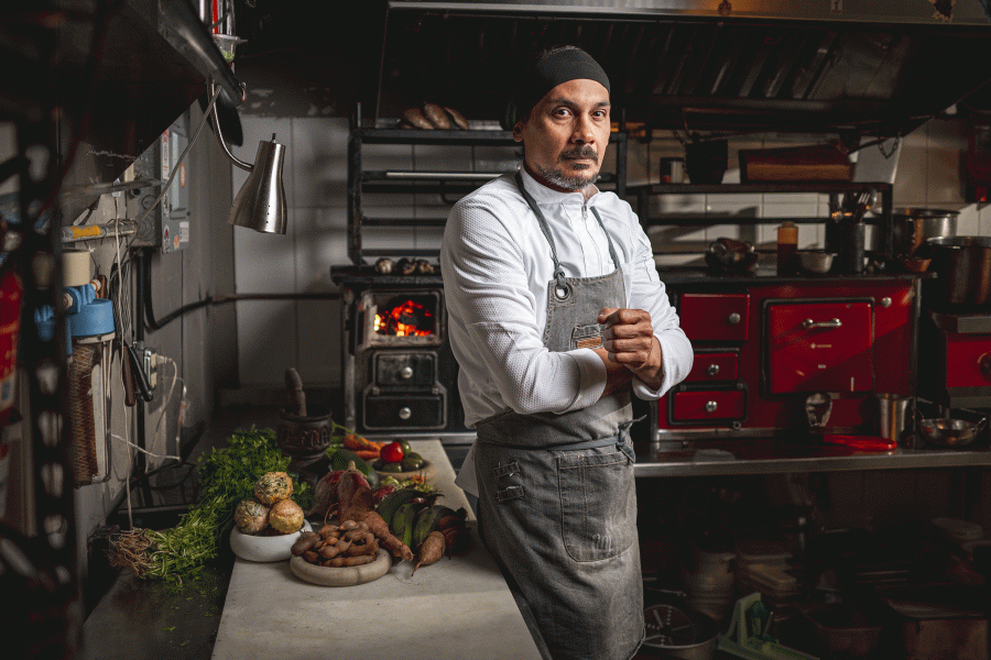 Chef Carlos Portela poses in his kitchen