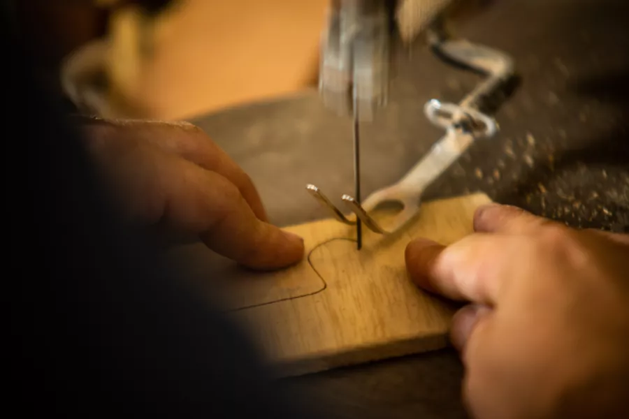 Artisan carving wood.