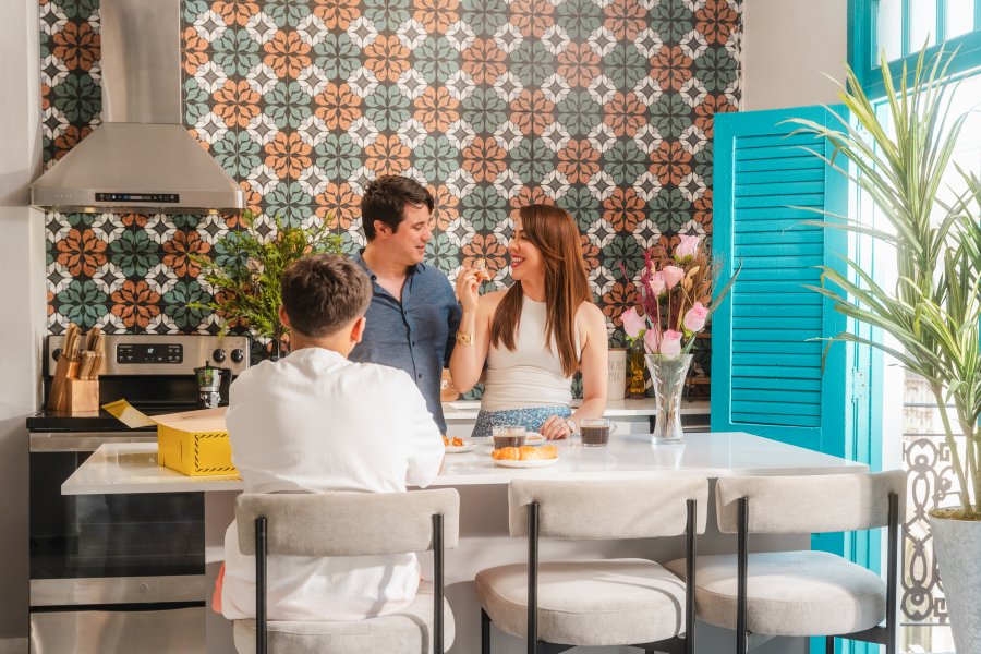 Family iin kitchen of short term rental.