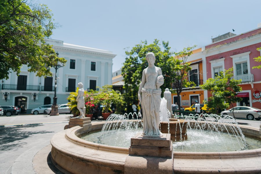 Plaza de Armas in Old San Juan, Puerto Rico, with fountain and surrounding colonial buildings.