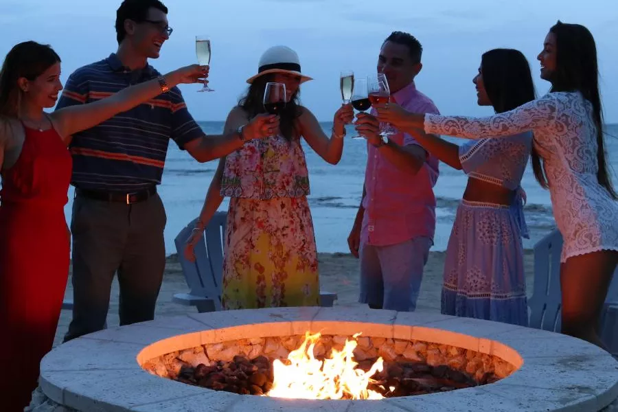 People enjoying the beach during the Noche de San Juan celebration in Puerto Rico, a tradition filled with magic and festivity.