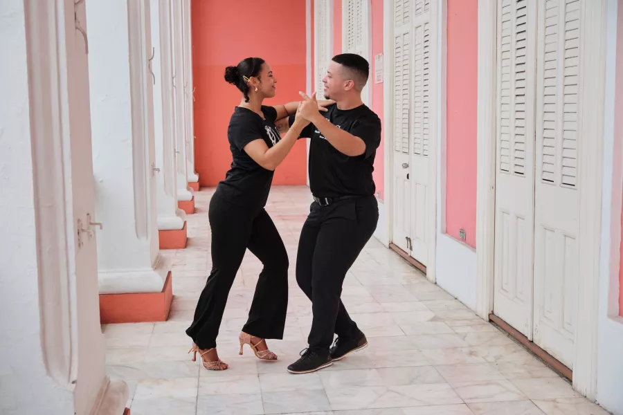 A couple dancing salsa in a colorful corridor in Ponce, Puerto Rico.