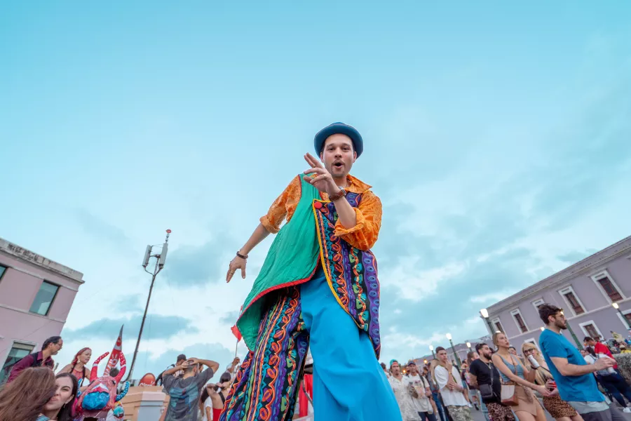 A colorful street performer entertains the crowd during the Fiestas de la Calle San Sebastián in Old San Juan, Puerto Rico.
