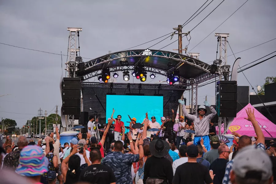 Concertgoers enjoy a live outdoor music performance at a festival in Puerto Rico, celebrating the Island's vibrant music scene.