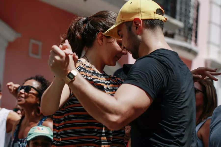 A couple dancing in front of a building in Old San Juan, Puerto Rico.