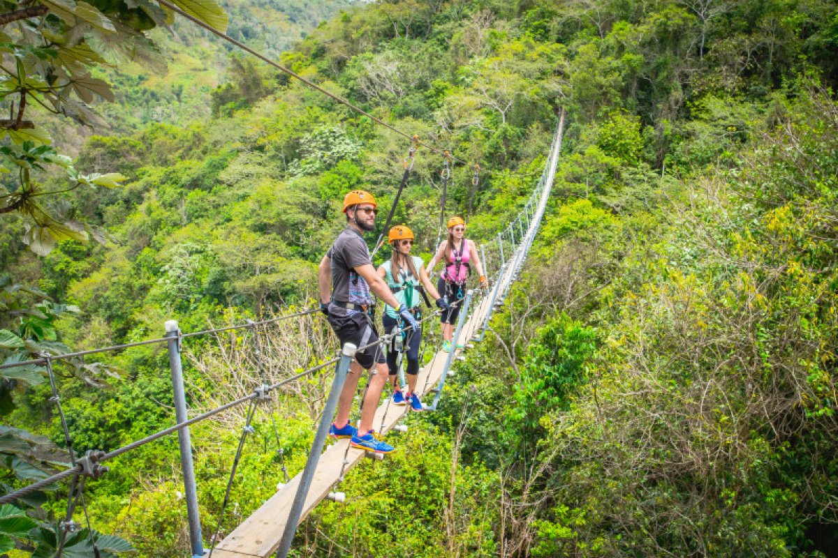 A family crosses a suspension bridge.