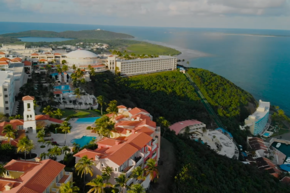 Aerial view of a cliffside resort with views of the ocean.