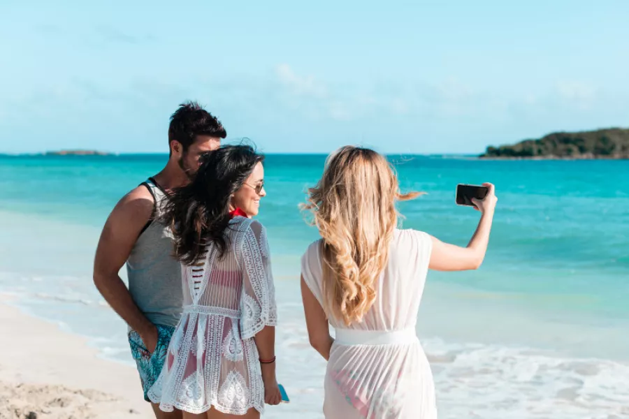 Friends taking a selfie on the soft white sands of a Vieques beach.