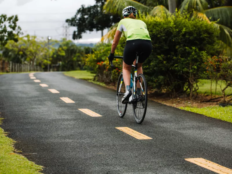 Biker biking along a scenic pathway in Paseo Lineal, Bayamón's Central Park. 