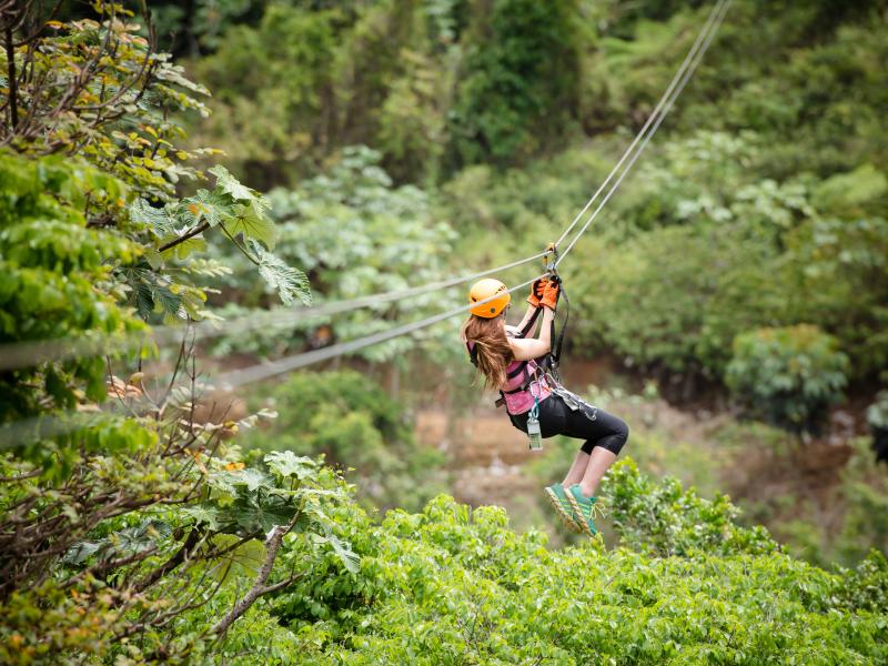 A woman flies down a zipline at Toro Verde Adventure Park.