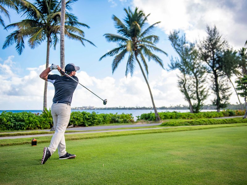 A golfer plays one of the three scenic golf courses at Dorado Beach, a Ritz-Carlton Reserve. 