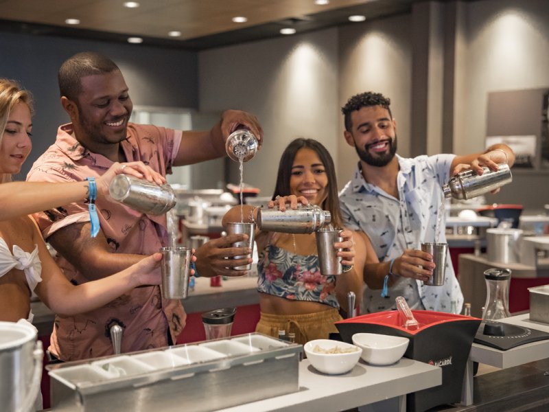 A group of people enjoy a cocktail mixology class at Casa Bacardi Rum Distillery.