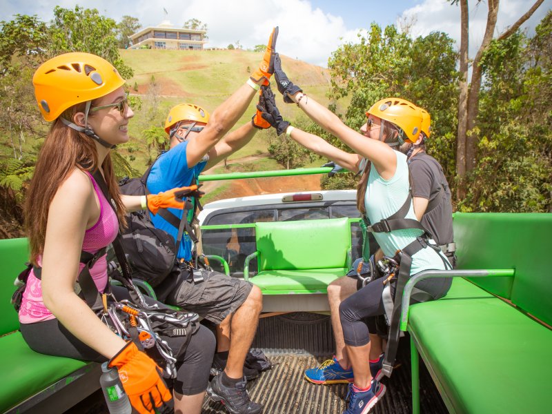 A group high-fives after an activity at Toro Verde Nature Adventure Park.