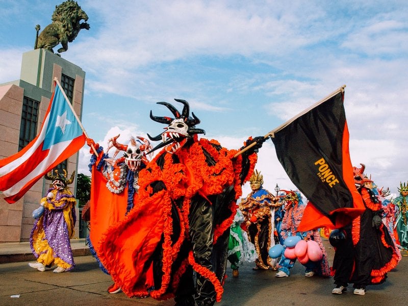 Revelers in traditional vejigante costumes at Carnaval Ponceño.