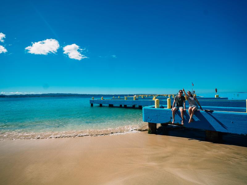 Two people enjoying Crashboat Beach in Aguadilla.