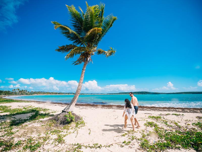 A couple strolling through the stunning Esperanza beach in Vieques.