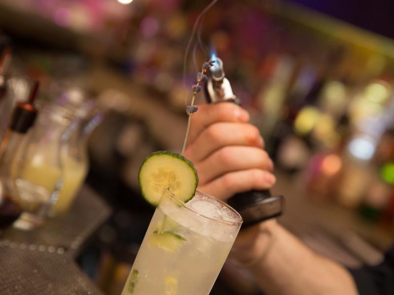 A bartender prepares an elaborate craft cocktail at Gallo Negro.