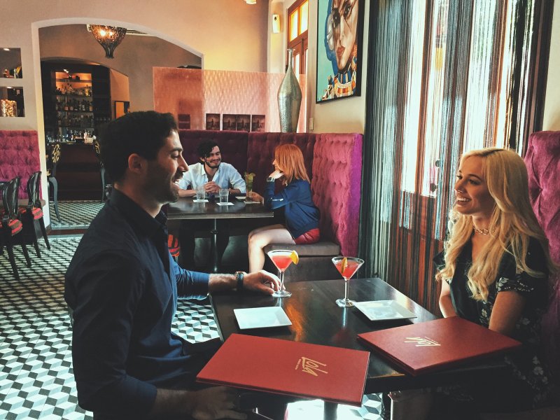 A couple enjoys their cocktails at a restaurant in Ponce.