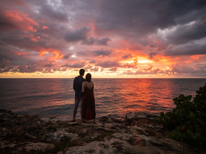 A couple watches the sunset at Cabo Rojo