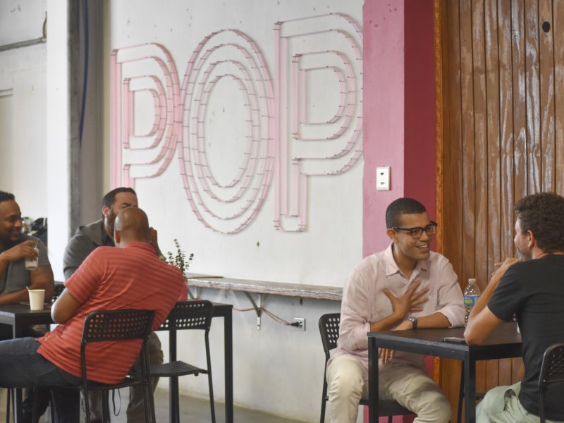 people sitting at tables and talking in POP in Santurce