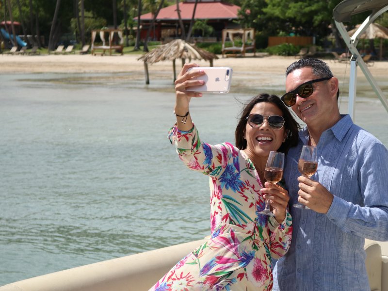 Couple taking a selfie in front of the beach in Copamarina Resort in Guanica