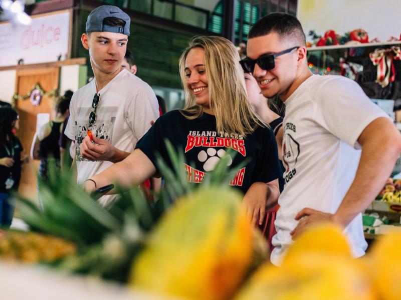 Youth groups exploring a local food market.