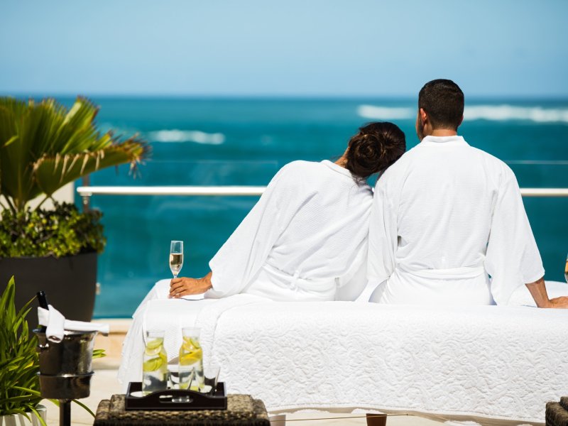 A couple watching the ocean from the Condado Vanderbilt hotel.