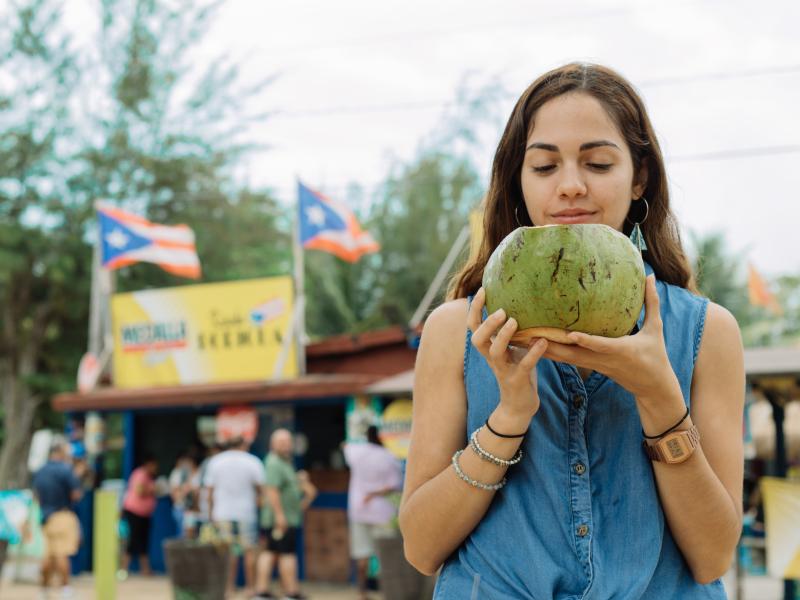 Girl drinks coconut water at Piñones.