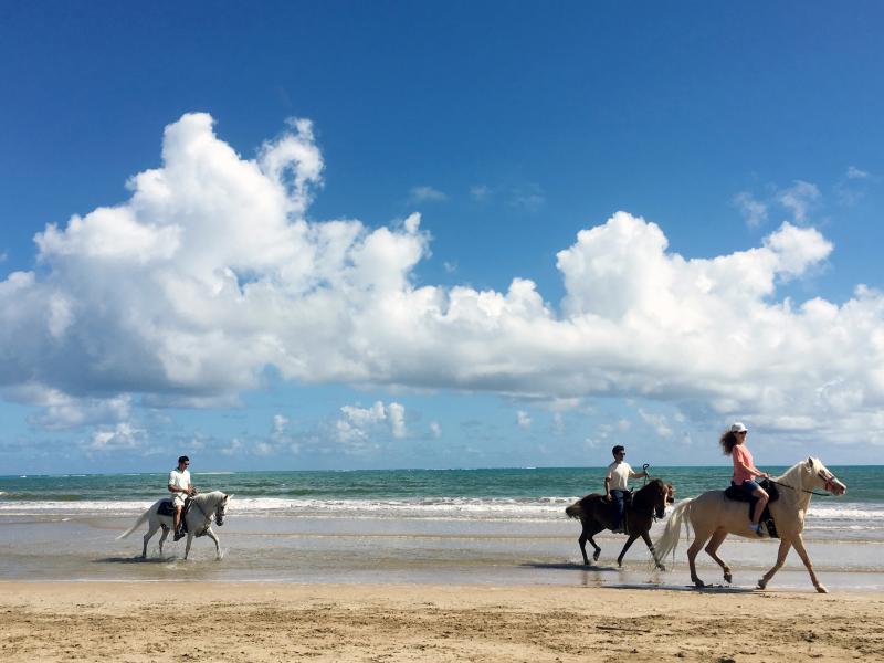 Horseback riding in the beach.