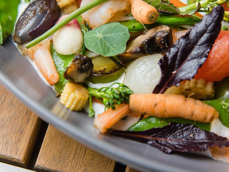 A plate with a spring salad from a vegan restaurant. 